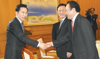 이명박 대통령(왼쪽)이 7일 오전 주요 20개국(G20) 정상회의 결과를 설명하기 위해 주요 경제단체장을 청와대로 초청한 자리에서 사공일 한국무역협회장 겸 G20기획조정위원장과 악수를 나누고 있다. 청와대사진기자단