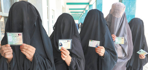 아프간 대선… 탈레반 선거 방해 기승2001년 탈레반 정권 붕괴 이후 아프가니스탄에서 두 번째 대통령선거가 치러진 20일(현지 시간) 수도 카불 남쪽 칸다하르 주의 한 학교에 마련된 투표소에서 부르카를 차려입은 여성들이 차례를 기다리며 신분증을 꺼내 보이고 있다. 탈레반의 선거 저지 공격이 극에 달한 가운데 투표가 진행돼 전국 투표소에는 경찰이 대거 투입되는 등 보안이 엄격하게 이뤄졌다. 탈레반의 주 무대인 남부 지역의 투표율은 매우 낮았다. 칸다하르=AFP 연합뉴스