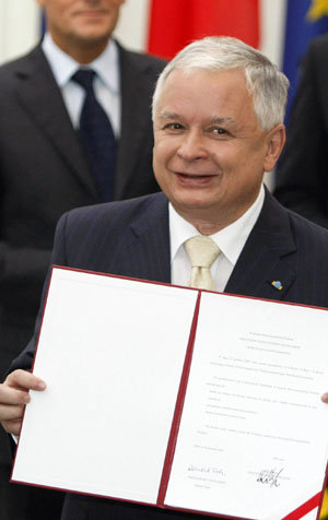 폴란드의 레흐 카친스키 대통령이 10일 바르샤바 대통령궁에서 자신이 서명한 리스본조약 비준안을 들어 보이며 환하게 웃고 있다. 바르샤바=로이터 연합뉴스