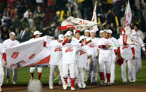 24일 서울 잠실야구장에서 열린 2009프로야구 한국시리즈 7차전 KIA타이거즈 대 SK와이번스의 경기. 5:5 동점 상황 9회말 1사 상황에서 KIA 나지완이 SK 마무리 투수 채병용을 상대로 결승 솔로 홈런을 날리며 경기 종료, KIA가 V10 달성에 성공했다. KIA 선수들이 그라운드를 돌며 우승 세리머니를 하고 있다. 잠실 | 양회성 기자 yohan@donga.com