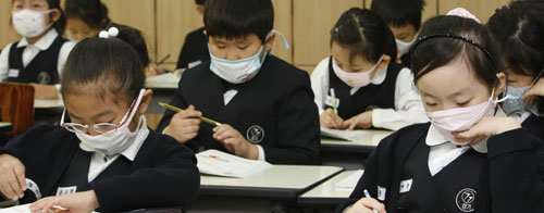 전교생 마스크 수업일선 학교를 중심으로 신종 인플루엔자가 급속도로 확산되자 서울 경기초등학교 학생들이 마스크를 쓴 채 수업을 받고 있다. 경기초등학교는 최근 학생들에게 마스크를 쓰고 등교하라고 지시했다. 김재명 기자