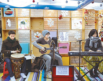 서울 중구 황학동 신당창작아케이드에서 21일 열린 ‘크리스마스 길몽’에 출연한 예술인들이 지역 주민들 앞에서 공연을 펼치고 있다. 사진 제공 서울문화재단