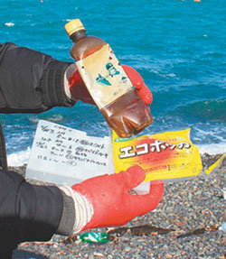 7일 전남 여수시 동고지 해안에서 발견된 외국 쓰레기들. 대만 야구 선수가 그려진 플라스틱 음료수병과 일본 비디오테이프 케이스 등이 해류를 타고 떠밀려온 것으로 추정된다