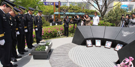 3일 오전 부산지방경찰청 동백광장 앞에서 열린 동의대사건 순국 경찰관 21주기 추도식에서 부산지방경찰청 소속 경찰관들이 분향한 뒤 묵념하고 있다. 오른쪽에 있는 구조물은 동의대 순국 경찰 추모비다. 부산=최재호 기자