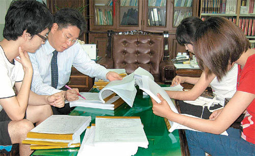 세명대 한의대 김호현 학장(왼쪽에서 두 번째)이 학생들과 시험답안을 보고 있다. 세명대는 리포트나 시험답안 제출 후 학생들에게 피드백을 주는 ‘빨간펜 제도’를 시행하고 있다. 제천=장기우 기자