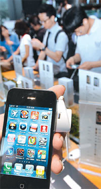 아이폰4의 국내 판매가 시작된 10일 출시 행사가 열린 서울 종로구 세종로 KT 올레스퀘어에서 구매 예약자들이 몰려 아이폰4를 시연해보고 있다. 홍진환 기자 jean@donga.com
