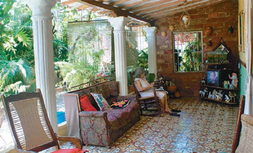 A sunny terrace greets the visitor in the center of the house. Grandma Alicia Florence Lamores is taking a rest by watching television on a rocking chair.