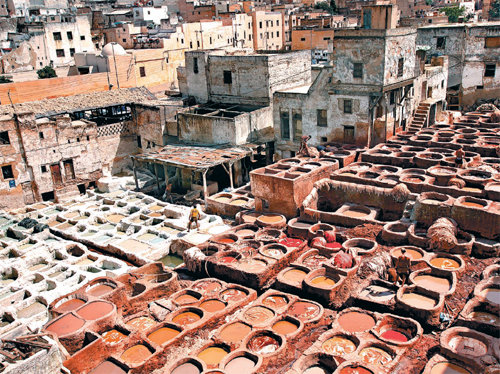Chouara Tannery viewed from five stories above. Fes has maintained its tradition of pigmenting leather with natural ingredients for hundreds of years. The place reeked of dye and filth, but products made of lamb and goat leather boasted their beauty in colorful shades.