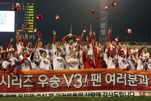 “오 해피데이!”  2년 만에 나온 페넌트레이스와 한국시리즈 통합우승이다. SK 선수단이 우승을 확정지은 뒤 팬들에게 감사인사를 전하는 현수막을 들고 모자를 하늘 위로 던지며 환호하고 있다.