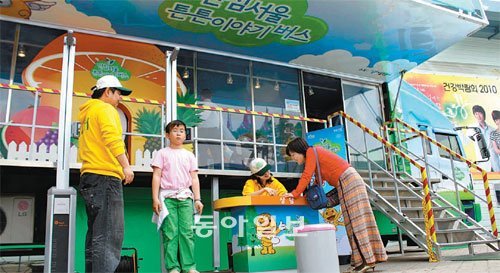 5월 서울시가 마련한 ‘안심 서울 튼튼이야기 버스’ 프로그램에 참가한 한 어린이가 키와 몸무게를 측정하고 있는 가운데 학부모가 전문가와 식습관에 대해 상담하고 있다. 사진 제공 서울시