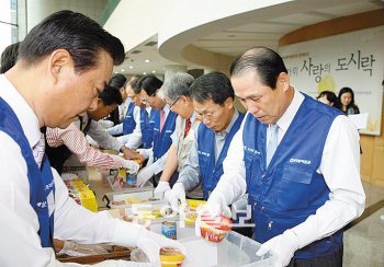 우리투자증권 직원들이 지난해 9월 경북 경주시 종합사회복지관에서 ‘사랑의 도시락 행사’를 열었다. 우리투자증권 제공