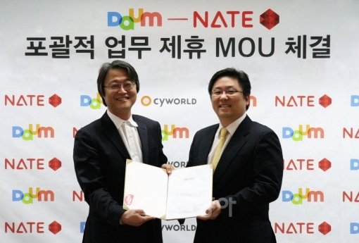 14일 서울 서대문구 SK커뮤니케이션즈 사옥에서 주형철 SK커뮤니케이션즈 대표(왼쪽)와 최세훈 다음커뮤니케이션 대표가 포괄적 업무제휴에 대한 양해각서를 체결하고 사진촬영을 위해 포즈를 취하고 있다.