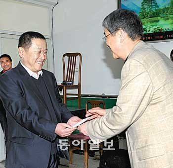 2010년 중국 옌지의 한센병 요양원을 방문한 성라자로 마을 원장 조욱현 신부(오른쪽)가 요양원 관계자에게 성금 1만 달러를 전달하고 있다. 성라자로 마을 제공