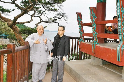 주지 스님의 소임을 내려놓고도 복원 불사를 주도하고 있는 낙산사 한주 정념 스님(왼쪽)과 정호승 시인이 10일 의상대 옆에서 낙산사의 미래를 주제로 이야기를 나누고 있다. 뒤편의 나무는 사진작가들이 국내에서 가장 ‘잘생긴’ 것으로 꼽는 의상대 소나무로 화재의 후유증을 앓고 있어 특별히 보호받고 있다. 양양=김갑식 기자 dunanworld@donga.com