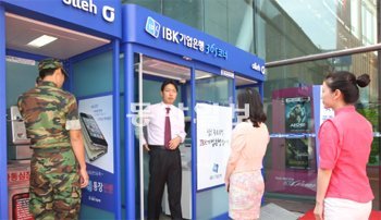 7일 서울역 신청사 2층 광장에 마련된 ‘IBK 길거리점포’ 앞에서 시민들이 현금자동입출금기(ATM)를 이용하기 위해 줄을 서서 기다리고 있다. 기업은행 제공