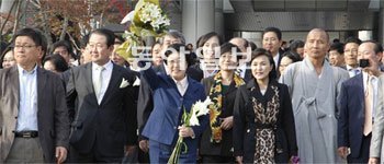 31일 무죄를 선고받은 한명숙 전 총리(왼쪽에서 세 번째)가 서울 서초구 서초동 서울중앙지법에서 지지자들에게 둘러싸인 채 축하 꽃다발을 흔들어 보이고 있다. 한 전 총리의 얼굴에 미소가 가득하다. 김재명 기자 base@donga.com