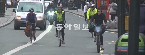 지난달 28일 오전 영국 런던 화이트홀 거리에서 시민들이 자전거를 타고 있다. 런던에서는 교통 혼잡을 피하고 온실가스 배출을 줄이기 위해 자전거를 이용해 출퇴근하는 시민이 많다.