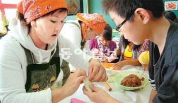 여수에 사는 몽골 출신 이주여성 희식 벨게르 씨(35)가 이달 초 여수 신월초등학교 6학년 학생들과 함께 몽골음식을 만들고 있다. 여수시 다문화가족지원센터 제공