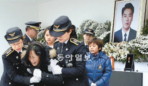 14일 오전 인천 중구 북성동 인천해양경찰서 전용부두에서 열린 이청호 경사 영결식에서 부인 윤경미 씨가 헌화한 뒤 오열하고 있다. 인천=김재명 기자 base@donga.com