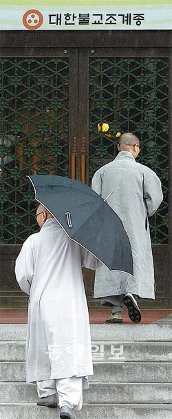 일부 스님들의 도박 사건으로 위기를 맞고 있는 조계종이 14일 서울 견지동 불교역사문화기념관에서 잇달아 긴급 대책회의를 열었다. 비가 부슬부슬 내리는 가운데 스님들이 비공개로 열린 회의에 참석하기 위해 기념관으로 들어서고 있다. 김재명 기자 base@donga.com