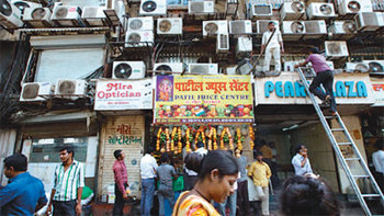 인도 뭄바이 슬럼가의 한 아파트. 낡은 건물 한 면을 에어컨 실외기가 다닥다닥 채우고 있다. 창문마다 실외기가 너무 많이 달려 있어 위험해 보이기까지 한다. 뉴욕타임스 본사 특약