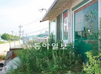 잡초만 무성 문을 닫은 강원 고성군 현내면 명파리의 한 음식점 앞에 잡초가 무성해 을씨년스러운 풍경을 연출하고 있다. 2008년 7월 금강산 관광이 중단된 이후 고성에서는 159개 음식점이 문을 닫는 등 최악의 경기 침체를 겪고 있다. 이인모 기자 imlee@donga.com