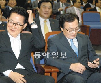 곤혹스러운 대표들 11일 국회에서 열린 민주통합당 의원총회에서 이해찬 대표(오른쪽)와 박지원 원내대표가 의원들의 발언 도중 휴대전화를 확인하거나 머리를 긁적이며 곤혹스러운 표정을 짓고 있다. 안철민 기자 acm08@donga.com