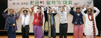 삼성중공업이 개최한 ‘제1회 외국인 직원 한국어 말하기 대회’의 참가자들이 양팔로 하트를 그리며 미소 짓고 있다. 이 회사는 800명에 이르는 외국인 직원과 한국인 직원들이 서로 잘 이해하고 소통할 수 있도록 올해 처음 이 대회를 열었다. 삼성중공업 제공