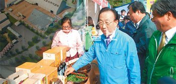 경북 문경새재에 열린 대한민국 마을기업 박람회에서 김관용 경북도지사가 참가기업 제품을 살펴보고 있다. 경북도 제공