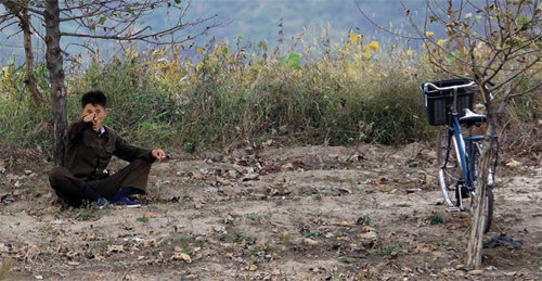 고요한 일상이 깨져서 화가 났을까. 위화도 압록강변에서 담배를 피우던 북한 청년이 기자를 보면서 고함을 치고 있다.