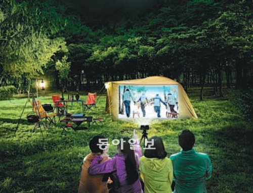 캠핑객들이 빔프로젝터를 이용해 캠핑장에서 영화를 보고 있는 모습. LG전자 제공