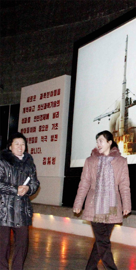 기뻐하는 北주민들 북한이 장거리로켓을 발사한 12일 북한 주민들이 평양 3대혁명전시관을 둘러보며 환하게 웃고 있다. 평양=AP 연합뉴스