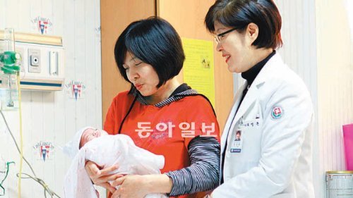 사오마이의 엄마 돈티김흐엉 씨(왼쪽)가 9일 전남대병원에서 사오마이를 퇴원시키면서 최영륜 교수와 함께 활짝 웃고 있다. 전남대병원 제공