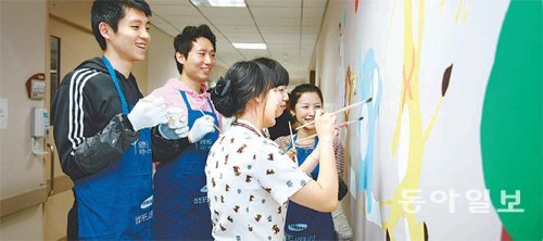 삼성카드 임직원들이 고려대 구로병원의 어린이 병동을 방문해 벽화를 그려주는 봉사 활동을 하고 있다. 삼성카드 제공