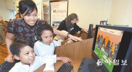 21일 인도네시아 욕야카르타에 문을 연 ‘KT-공신 이러닝센터’에서 현지 대학생 교사들이 저소득층 학생들에게 교육 봉사활동을 벌이고 있다. KT 제공