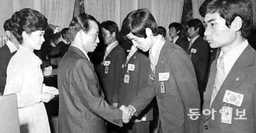 박정희 전 대통령이 1977년 7월 18일 제23회 국제기능올림픽에서 종합 1위를 한 선수단을 청와대에 초청해 훈장과 부상을 수여하고 있는 모습. 당시 박 대통령은 퍼스트레이디 역할을 했다. 동아일보DB