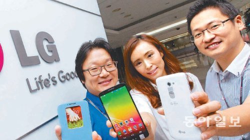 LG전자가 새로 내놓은 전략 스마트폰 ‘G2’ 개발의 주역인 송수용 책임연구원, 오세숙 선임연구원, 정장재 과장(왼쪽부터)이 23일 LG전자 MC연구소에서 G2를 손에 들고 환하게 웃고 있다. LG전자 제공