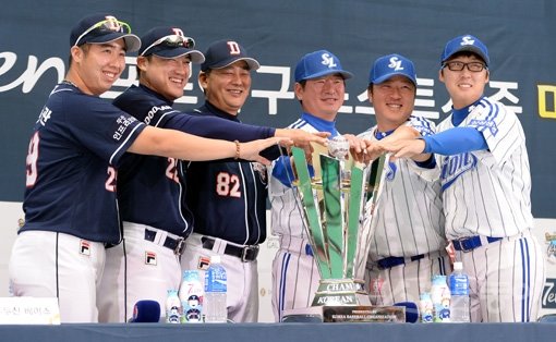 23일 오후 2시 대구 시민체육관에서 ‘2013 한국야쿠르트 세븐 프로야구 한국시리즈’ 미디어데이가 열렸다. 미디어데이에 참석한 양팀 감독과 선수들이 우승트로피에 손을 대고 기념촬영을 하고 있다. 대구｜김종원기자 won@donga.com 트위터@beanjjun