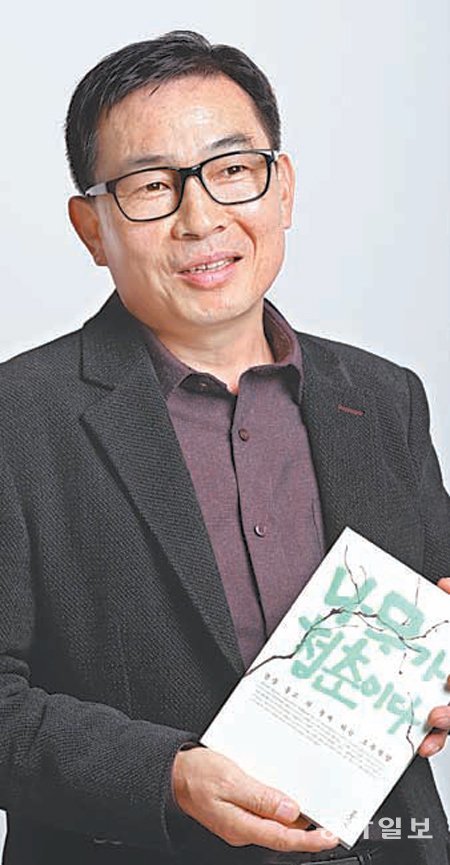 13일 오후 서울 광화문 인근에서 만난 고주환 씨가 자신의 책 ‘나무가 청춘이다’를 들고 나무에 얽힌 자신의 인생을 설명하고 있다. 신원건 기자 laputa@donga.com