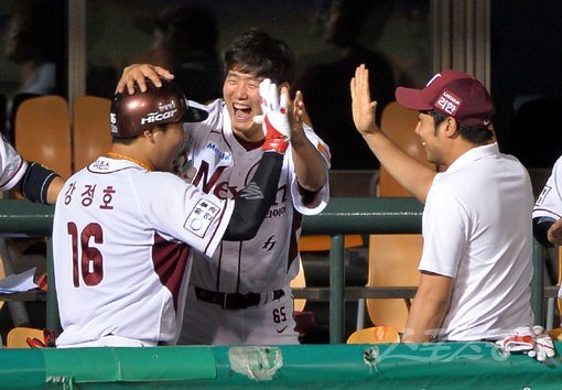 넥센 강정호(왼쪽)가 27일 목동 KIA전에서 4-4로 맞선 8회 솔로홈런을 터뜨린 뒤 동료들의 환호를 받고 있다. 이 홈런으로 강정호는 유격수 최초로 30홈런-100타점 고지를 정복했다. 목동｜임민환 기자 minani@donga.com 트위터 @minani84