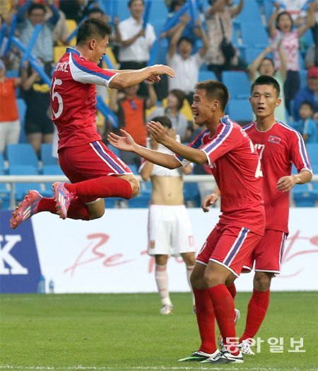 “만리장성 넘었다” 북한 남자축구대표팀 이혁철(왼쪽)이 15일 인천축구전용경기장에서 열린 아시아경기 남자축구 조별리그 F조 중국과의 1차전에서 2-0으로 앞선 후반 12분 쐐기골을 터뜨린 뒤 동료들과 환호하고 있다. 북한이 3-0으로 예상 밖의 대승을 거뒀다. 인천=양회성 기자 yohan@donga.com