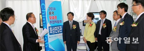 우만선 한국산업인력공단 북경대표처 대표(왼쪽에서 두 번째)가 19일 중국 베이징 한국문화원에서 열린 ‘맞춤형 취업박람회’에서 화상 면접에 대해 행사 관계자들에게 설명하고 있다. 구자룡 특파원 bonhong@donga.com