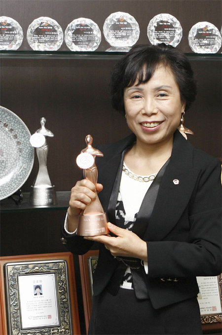 한화생명 영등포지역단 양남지점 보험설계사 박선녀씨가 올해 6월 받은 연도상 동상 트로피를 들고 환하게 웃고 있다. 연도상은 매년 우수한 영업 실적을 낸 설계사들에게 한화생명이 주는 상이다. 한화생명 제공