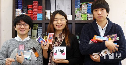 서울 서초구에 있는 ‘부끄럽지 않아요!’ 사무실에서 17일 박진아 씨(가운데)가 동료인 김석중(왼쪽), 성민현 씨와 함께 판매하는 콘돔을 들고 환하게 웃고 있다. 홍진환 기자 jean@donga.com