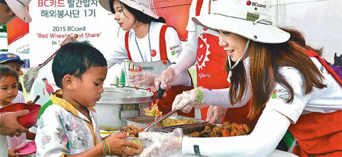 지난달 30일 필리핀 레이테 주 타나우안 시 말라기카이 초등학교에서 BC카드 ‘빨간밥차’ 봉사활동에 참여한 봉사단원들이 초등학생 240여 명에게 점심을 나눠주고 있다. BC카드 제공