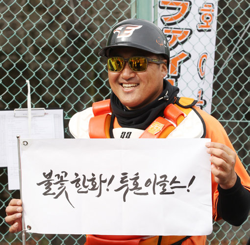 한화 조인성이 일본 고치 스프링캠프에서 2015시즌 캐치프레이즈 ‘불꽃 한화! 투혼의 이글스’라고 적혀 있는 깃발을 들고 환하게 웃고 있다. 조인성은 “올해 투수력이 지난해보다 강하다”고 말했다. 사진제공｜한화 이글스
