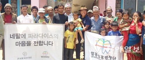 16일 긴급구호물품을 싣고 네팔 다딩 주 컬레리 마을을 찾은 엄홍길 대장(가운데 아이 안은 이)이 마을 사람들과 함께 환하게 웃고 있다. 다딩=박성진 기자 psjin@donga.com