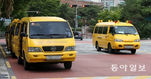 어린이 통학차량의 안전을 강화한 ‘세림이법’에 따른 단속이 29일부터 본격적으로 시작되지만 일부 차량에는 단속이 유예돼 논란이 되고 있다. 23일 서울 노원구 중계동의 학원가에서 구조 변경이 완료되지 않은 통학차량(왼쪽) 옆으로 경광등을 단 통학차량이 지나가고 있다. 장승윤 기자 tomato99@donga.com