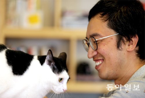 조춘배 씨가 작업실에서 키우는 고양이 ‘태평이’를 바라보며 웃고 있다. 김경제 기자 kjk5873@donga.com