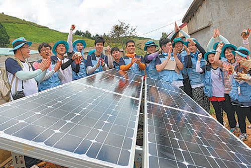 14일 베트남 손라 성 반호 현의 후아땃 마을의 한 학교에 태양광발전기를 설치한 한국전력 대학생 봉사단이 즐거운 표정을 짓고 있다. 한국전력 제공